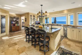 The kitchen is very spacious and offers an imposing island, plenty of counter space and working stations, walk-in pantry and a laundry room right next to it.