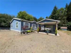 West side home with car port, detached garage & shop.