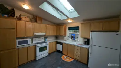 Light filled eat-in kitchen with skylights.