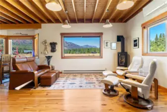 Gather in great room by glow of fireplace and gleaming hardwood floors with bucolic views out every window.