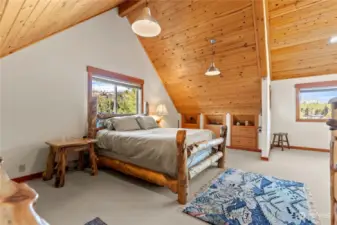 Loft Bedroom enjoys wall to wall carpeting, built in dressers, Wood ceilings with big timber features. Great views and natural light.
