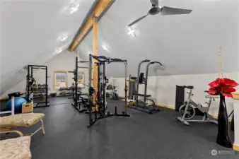 Spacious Gym area above Garage / shop. Well lighted. Ceiling fan. non slip floor. 1200 sf.