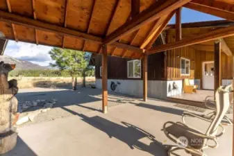 Covered Patio and Walkway between Home and Garage / Shop Workout room. Gravel surround, Concrete walkway patio and Trex deck to entry doors.