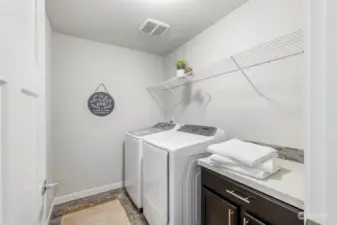 2nd floor laundry with storage and folding counter