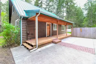 Entry side of home w/concrete patio between home & garage