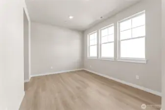 Big bright formal dining or sitting room with lots of natural light. Photo is representational. Home is under construction and finishes, features, and colors may vary. See site agent for details.