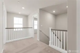 Open railing and vaulted ceiling at the entry of the home standard. Home is under construction and finishes, features, and colors may vary. See site agent for details.