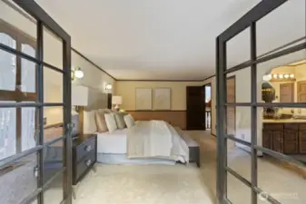 From the balcony looking in. This ore than ample primary suite can not only fit several dressers and/or pieces of furniture, there is also a walk-in closet, jetted tub with genuine vintage stained glass, and separate shower and W.C.