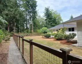 Fully fenced and updated landscaping creates the perfect backyard retreat.