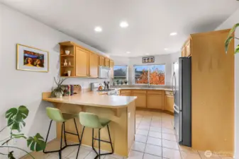 Kitchen with bar seating, ample cabinet space and  pantry just out of the shot to the right.