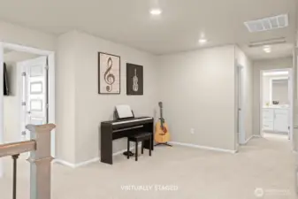 Primary bedroom to the left. This little nook is perfect for hobbies, toys, workout equipment, or reading.