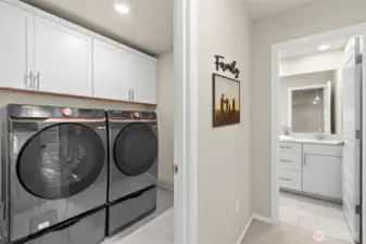 Upstairs laundry room with extra storage and elevated washer/dryer + lower appliance drawers included.