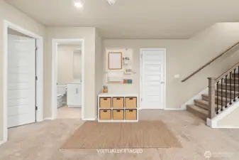 Lower rec room, with a large storage closet in back by the stairs. Bedroom #4 to the left.