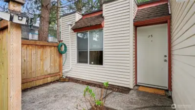 Charming private front patio offering a cozy setting for morning coffee or quiet relaxation.