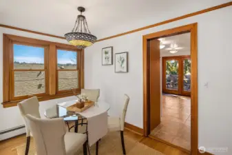 Sun filled eating nook with windows facing south and the kitchen with access to the back deck