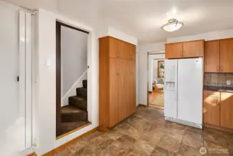 Large kitchen pantry and access to the primary suite upstairs
