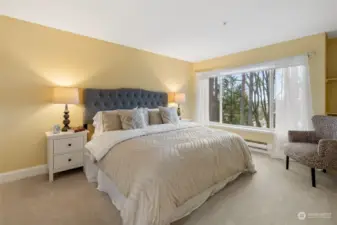 Primary Bedroom is spacious and has a large window looking out to the East with partial views of Lake Sammamish.