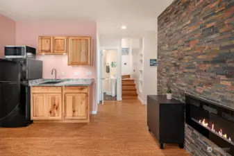 Living area has a small kitchenette (refrigerator, sink, and microwave). Tall ceilings. Steps on far wall are artistic, custom built koa wood for treads & risers with in-laid madrona end-grain rounds and indirect lighting...beautiful!!