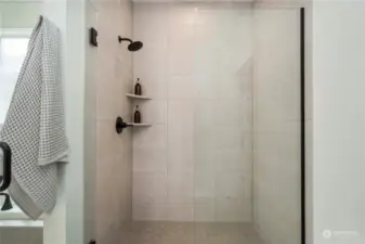 Fully tiled walk-in shower.