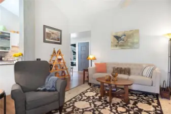 A view of the living room with the grey front door in the background. See the 3D MatterPort video on supplements for a closer and detailed look of the condo.