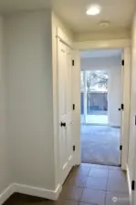 entry with view of 1st bedroom and sliding glass door to yard. (garage door access on right)