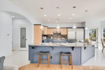 Bar wraps around 3 sides of the island; seating for everyone! Walk-in pantry on the left.