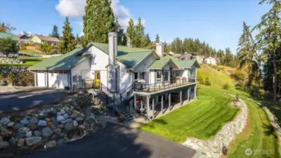 Terraced, lush yard with east-facing entertaining deck, covered back patio and spacious front patio