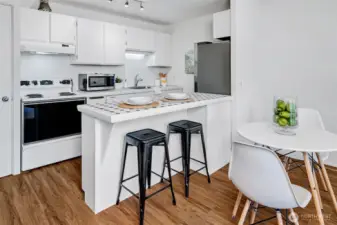 The open kitchen also has a breakfast bar for an easy meal or a place to sit and relax with a paper or book.