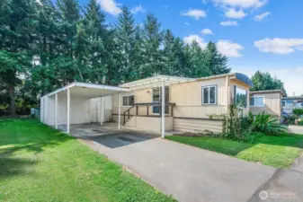 Welcome home! Spacious carport with   attached storage shed and easy access to the home’s entry.