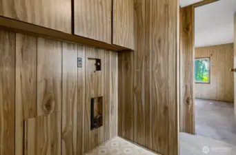 Dedicated laundry nook with hookups and storage cabinets, ready for your washer and dryer.