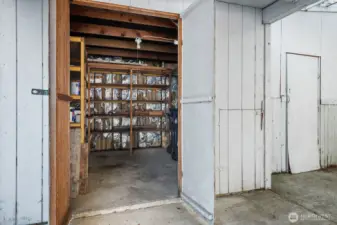 Workshop or storage area with built-in shelving and space for projects or extra storage needs.