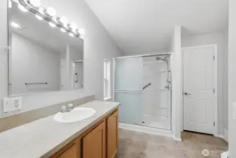 Primary bath with walk in shower and linen closet in the corner.