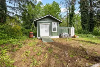 Handy storage shed for garden tools.