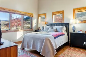 The second bedroom is equally comfortable with lots of natural light from wood-framed windows on 2 walls.
