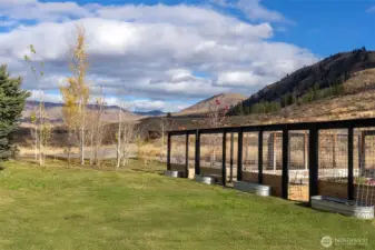 Adjacent to the guest house are a series of fenced dog runs and herb garden.
