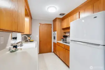 The kitchen offers plenty of counter space and storage, ideal for cooking and meal prep.