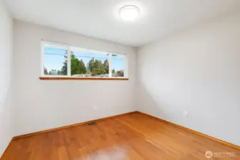 Bedroom 3. Original hardwoods also under carpet in hall & formal living room.