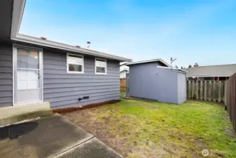 Enjoy the peaceful outdoor space with a private patio and storage shed.