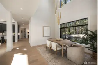 Dining area with custom 15' Mod lighting fixture over dining area