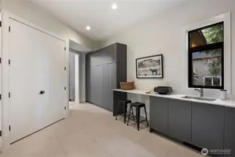 Large laundry/mudroom with sink and storage