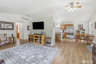 View from the corner left of the living area- looking at the kitchen eating area on the right and hall to the bedrooms on the left