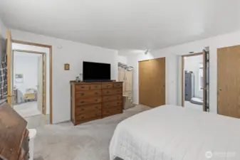 Primary bedroom. Picture taken from the bathroom door. Left door leads to hall to the house and right open door is large walk in closet