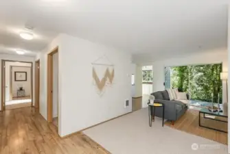 Open view of the entrance, living room, outdoor space with storage.  All new flooring through out.