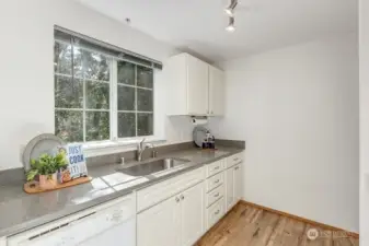 another view of the beautiful kitchen and private view of the back