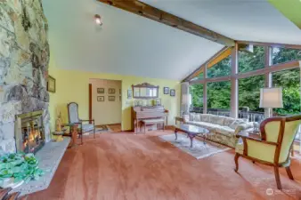 Vaulted ceilings and large picture windows from this spacious living room.