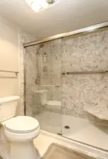 Walk-in shower with seat.