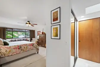 The entrance to the primary bedroom also leads to the primary bath to the right. Here you can see one of the several closets in the primary bedroom suite to accommodate your entire wardrobe.