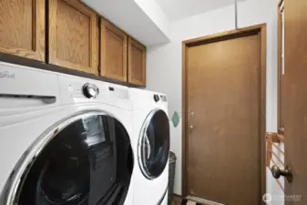 The laundry room is on the main floor and features a full sized, heavy duty, side by side washer and dryer. There are overhead cabinets and pedestal pull out drawers in this area to keep it very tidy and yet handy to the task at hand.