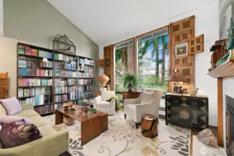 This photo shows the bookshelf wall and the vaulted lines of the ceiling.