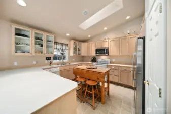 Large kitchen with skylight and pantry to the right.